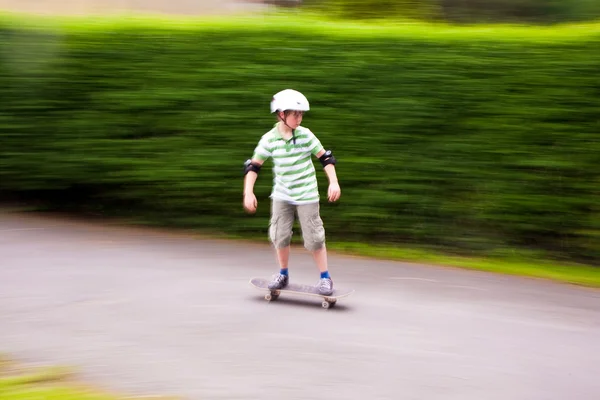 Jovem rapaz em seu skate bordo — Fotografia de Stock