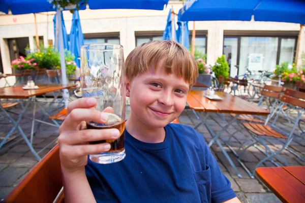 Fröhlich lächelndes Kind stößt mit Freude mit alkoholfreiem Dri an — Stockfoto