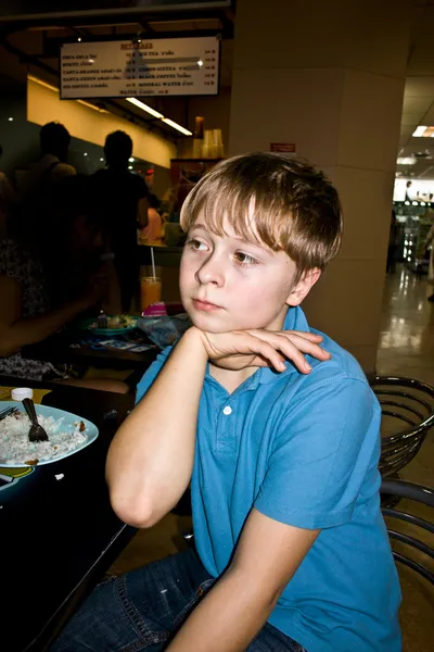 European boy enjoys resting in an asian restaurant — Stock Photo, Image