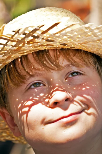 Menino com chapéu de palha é feliz e sorri — Fotografia de Stock