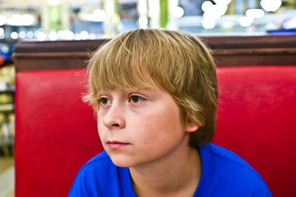 Smiling boy in a diners at night — Stock Photo, Image
