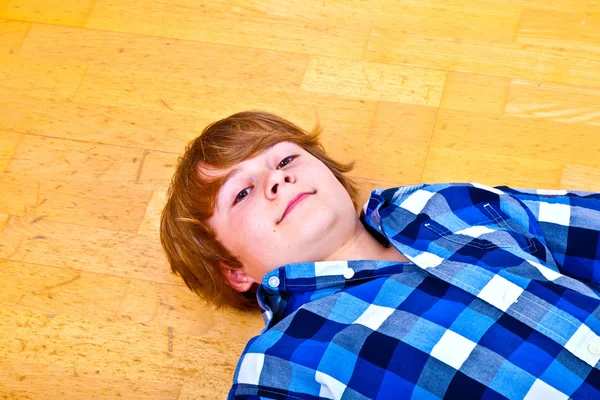 Boy lying at the floor — Stock Photo, Image
