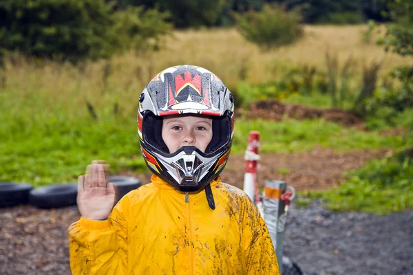 Happy boy with helmet at the kart trail — Stock Photo, Image