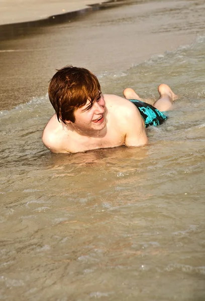 Happy boy with red hair is enjoying the beautiful beach Royalty Free Stock Photos