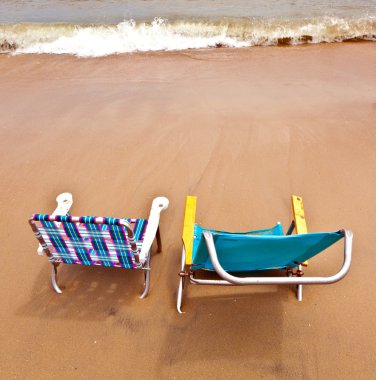 Beach with two chairs for relaxing clipart