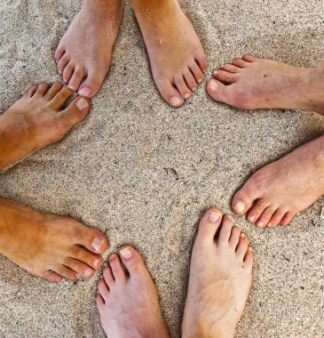 Feet of family at the beach clipart