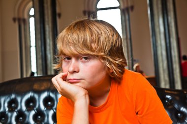 Boy takes a rest at a sofa clipart