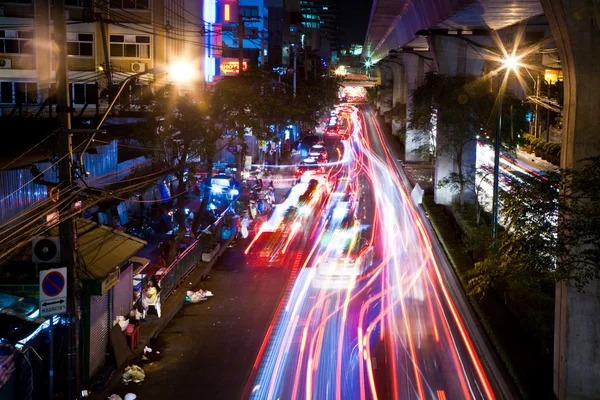Light beam at night from cars at the main road — Stock Photo, Image