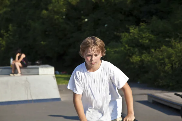 Boy with scooter is going airborne — Zdjęcie stockowe