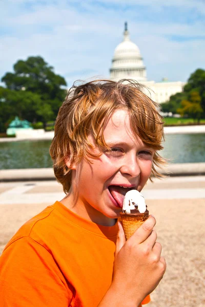 Un giovane ragazzo che mangia un gustoso gelato — Foto Stock