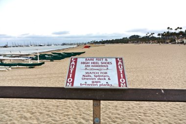 Warning for barefoot and high Heels at the pier in Santa Barbara clipart