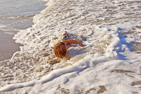 Niño tumbado en la playa y disfrutando del sol —  Fotos de Stock