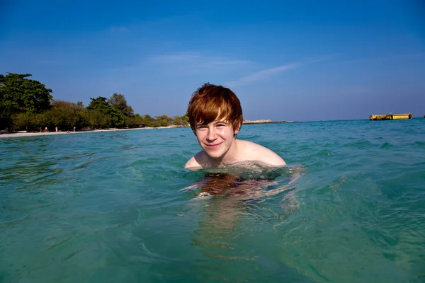 Κόκκινα μαλλιά αγόρι απολαμβάνει τα κρυστάλλινα νερά της θάλασσας — Φωτογραφία Αρχείου