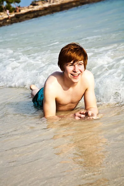 Щасливий хлопчик з рудим волоссям насолоджується прекрасним пляжем — стокове фото