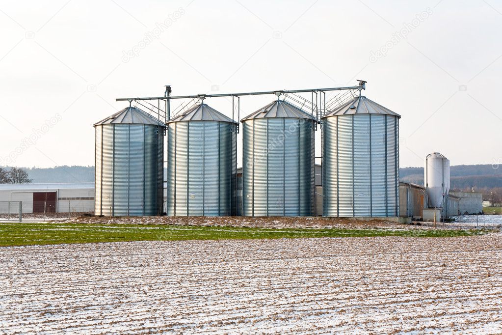 Acres with snow in winter with silo in beautiful light and struc