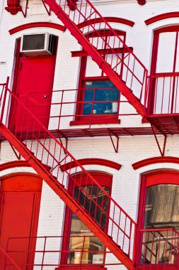 Fire ladder at old houses downtown in New York clipart