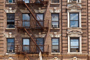 Fire ladder at old houses downtown in New York clipart