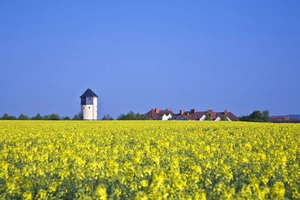 stock image Water tower in beautiful landscape with blue sky