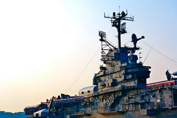 Aircraft carrier in sunset — Stock Photo, Image