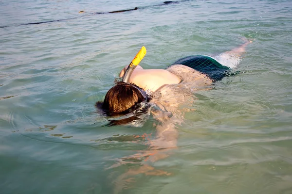 O rapaz está a mergulhar no mar limpo. — Fotografia de Stock
