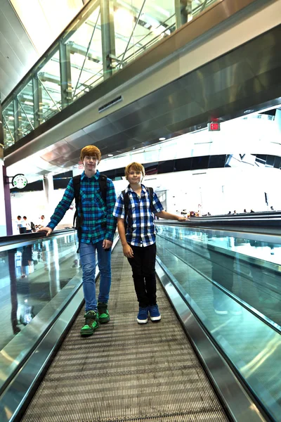 Young boy on a moving staircase inside the airport — Stock Photo, Image