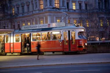 Red old trolley car in Vienna in the first District by night clipart