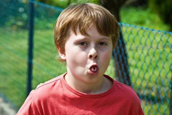 Boy shows his tongue — Stock Photo, Image