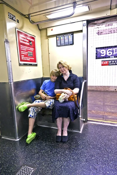 Ребенок с матерью, сидящей в метро — стоковое фото
