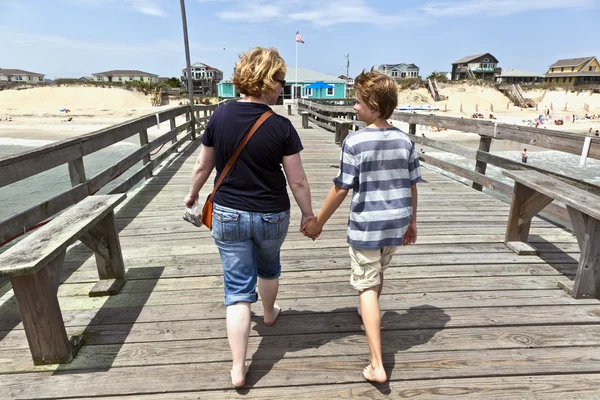 Anya és fia kéz a kézben járnak. — Stock Fotó