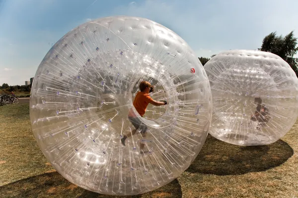 Child has a lot of fun in the Zorbing Ball — Stock Photo, Image