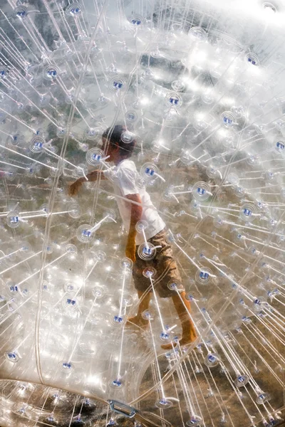 Child has a lot of fun in the Zorbing Ball — Stock Photo, Image