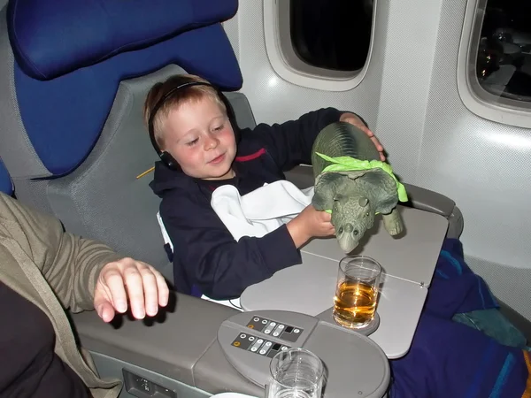 Chłopak daje jego snugglebun, dinozaur, coś do picia w — Zdjęcie stockowe