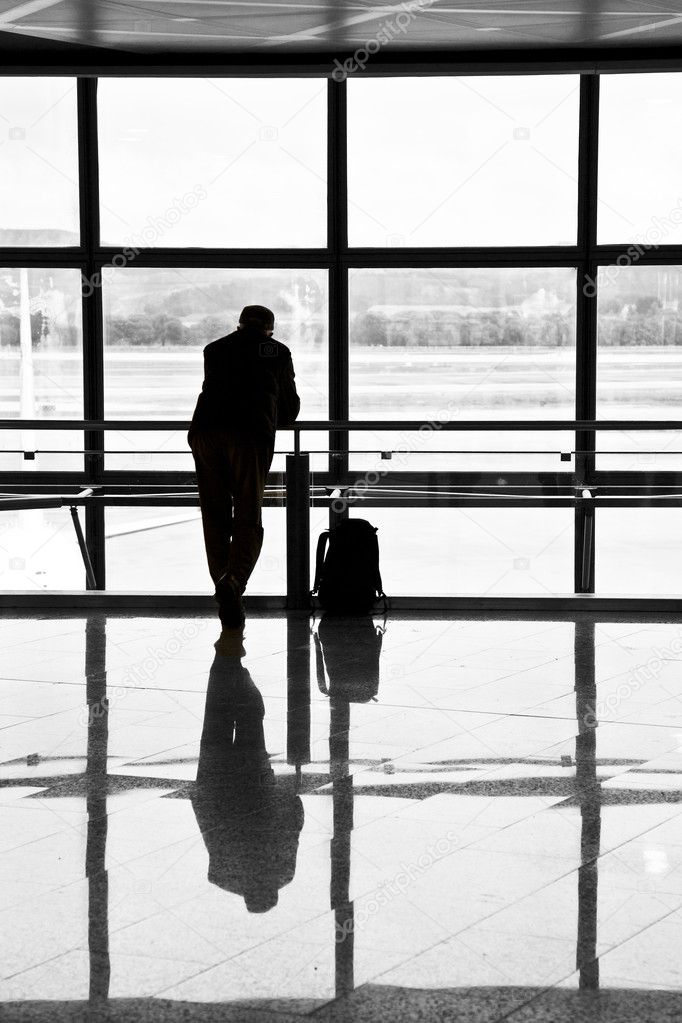 Man waiting for departure of his flight