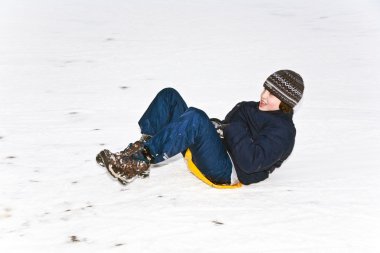 Children are skating at a toboggan run in winter on snow clipart