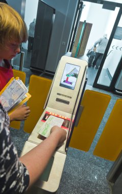 Passenger are using electronical boarding by scanning the bar co clipart