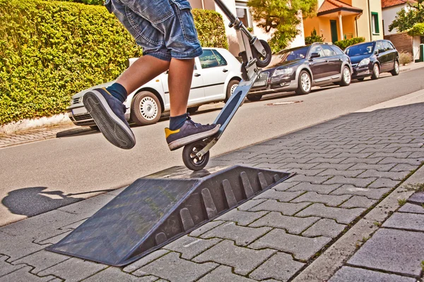Chico montando un scooter en el aire — Foto de Stock