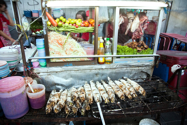 A street foodstand offers delicious fresh fish and vegetables