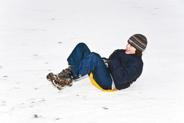 Children are skating at a toboggan run in winter on snow — Stock Photo, Image