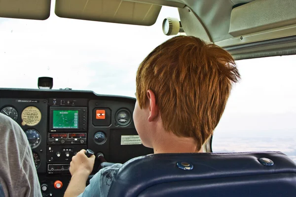 Joung boy is flying aircraft assisted by a trainer — Stock Photo, Image