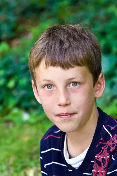 Portrait of a friendly seriously looking young boy — Stock Photo, Image
