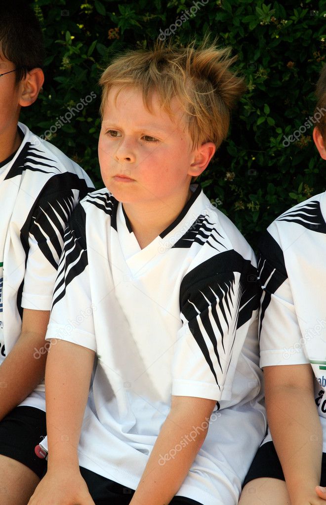 Boy is looking angry and sad from soccer playing because they ar