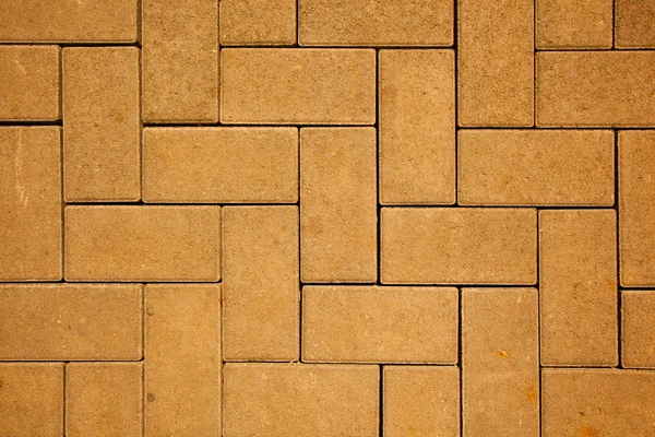 Bestrating patroon gemaakt met gegoten betonnen blokken in gele kleur — Stockfoto