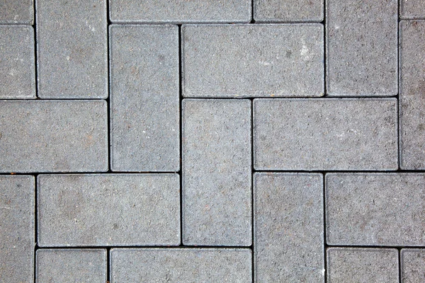 Bestrating patroon gemaakt met gegoten betonnen blokken in grijze kleur — Stockfoto