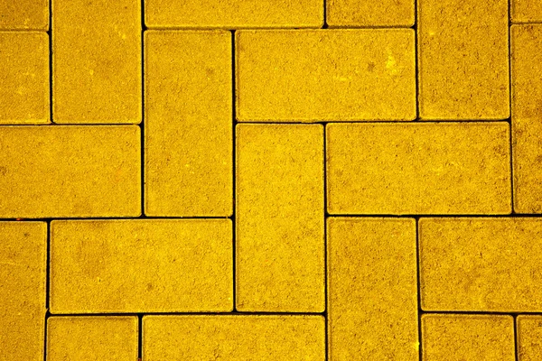 Pavement pattern made with cast concrete blocks in yellow color — Stock Photo, Image