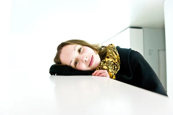 Portrait of an open smiling young girl in a white room — Stock Photo, Image