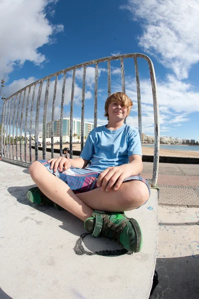 Lindo chico sentado en el parque de skate —  Fotos de Stock