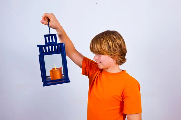 Cute boy holding a hand lantern — Stock Photo, Image