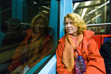 Beautiful woman looking out of the subway window clipart