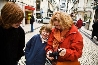 Family is happy and laughing by watching snapshots and pictures clipart