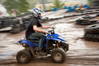 Young boy is faszinated by quad driving and enjoyes is, his face clipart